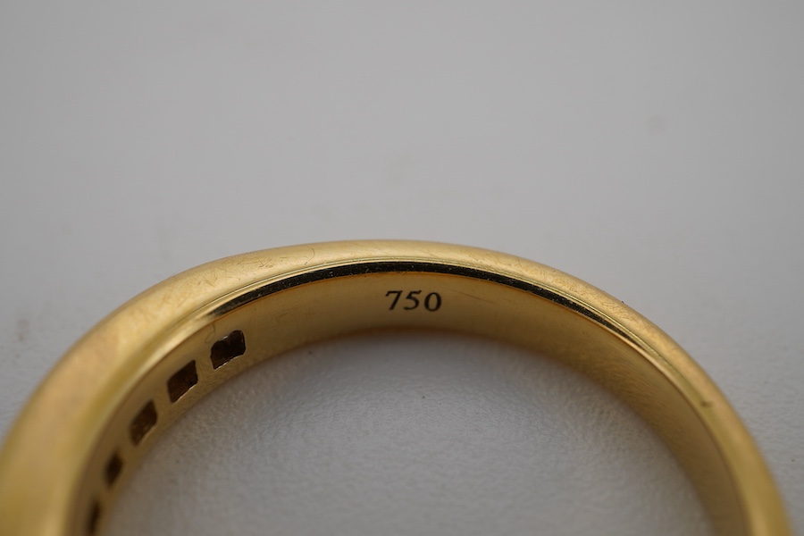 A diamond half hoop ring, channel-set to the front with princess-cut diamonds totalling approximately 0.60 carats, mounted in 18ct gold, size L, British hallmarks, gross weight approximately 4 grams